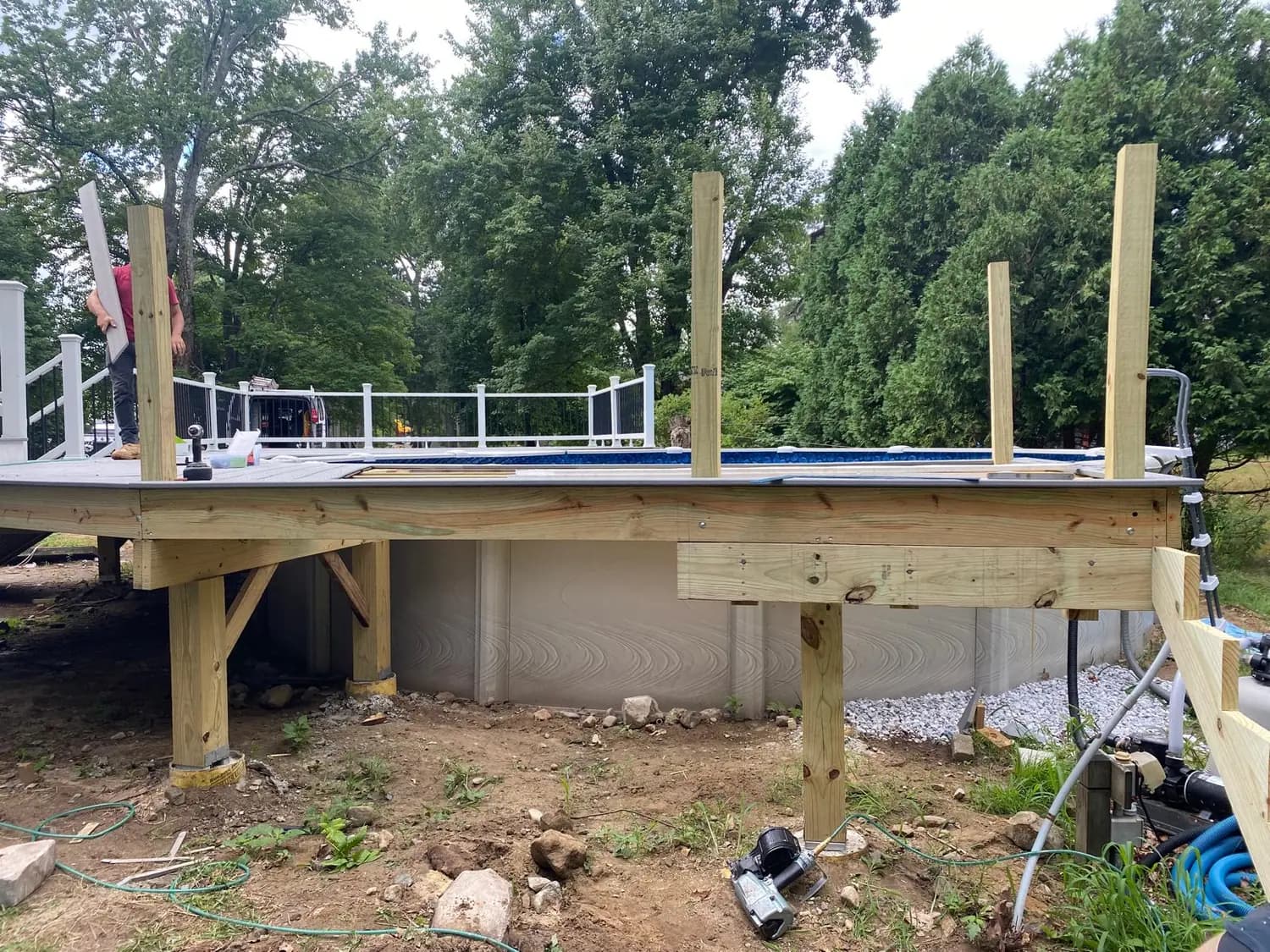 Pressure-treated posts and beams supporting a deck frame beside an above-ground pool, Salem, NH
